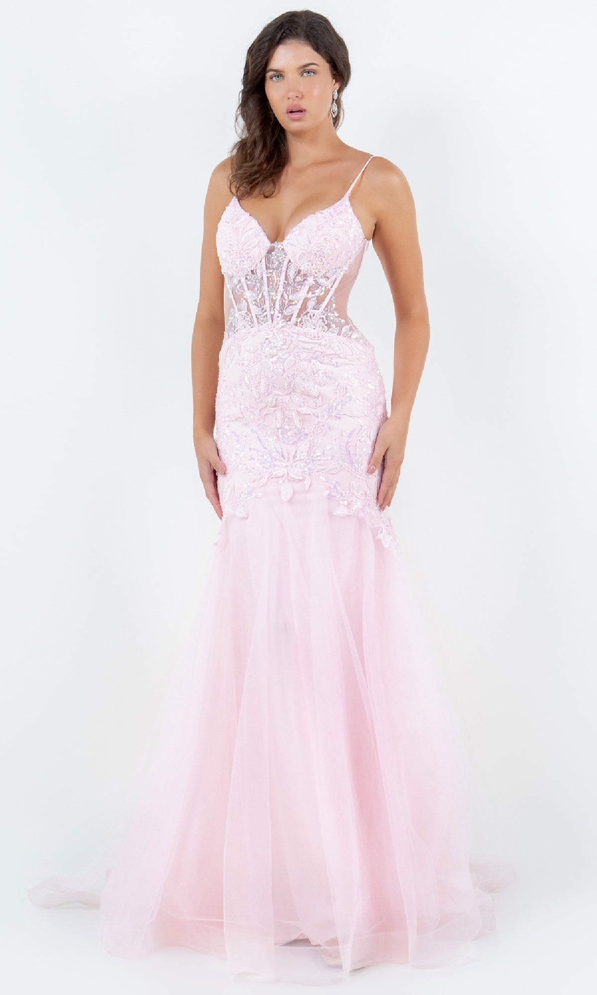 A woman wears the Long Mermaid Prom Dress: Cinderella Couture 8276J in light pink, featuring a sheer bodice and thin straps, floor-length style, standing against a plain white background.